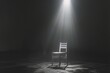 An empty chair and spotlight in a dark room
