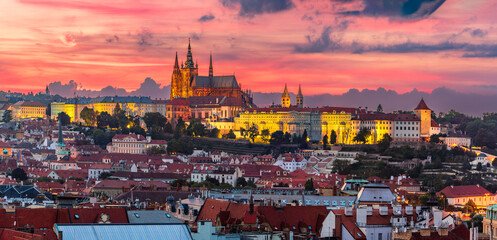 Wall Mural - The aerial view of UNESCO site Prague cityscape of downtown and the illuminated castle and the St. Vitus Cathedral in colorful twilight.