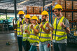 © chokniti - In a factory setting, a team of engineers and foremen emphasize safety and teamwork during a meeting, ensuring success in the construction industry.