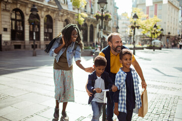 Poster - Happy family walking together on a city street with two children