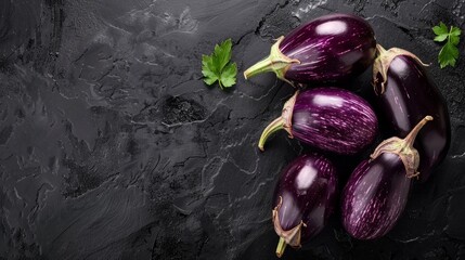 Wall Mural - A pile of glossy purple eggplants sitting on top of a table