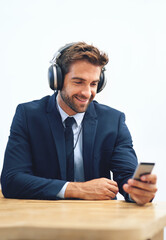 Canvas Print - Headphones, office and businessman with mobile phone for social media, browsing internet or streaming music. Smile, smartphone and male person listening to radio, audio podcast or online ted talk