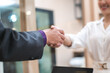 © chokniti - professional businessman person team meeting business partner for a deal agreements partnership job, using hand to make handshake with success teamwork, collaboration corporate work in office company