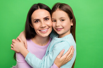 Poster - Photo of dreamy adorable little girl mom dressed casual clothes smiling embracing isolated green color background