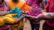 Hands / Palms of young people covered in purple, yellow, red, blue Holi festival colors isolated




