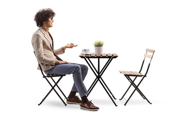 Poster - Profile shot of a young man sitting in a cafe and gesturing with hand