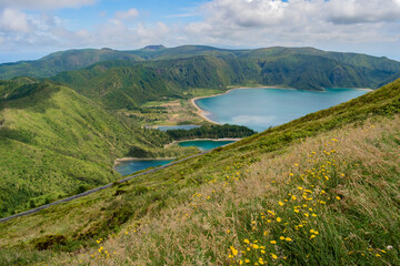 Wall Mural - Hill with wild flowers and herbs in aerial view to Fire Lagoon in volcanic caldera, São Miguel - Azores PORTUGAL