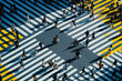 Busy pedestrian crosswalk in Tokyo, Japan during rush hour with people walking across the street from aerial view