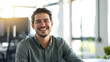 © Generative AI - Portrait of male software developer smiling at camera while sitting at workplace in office copy space : Generative AI