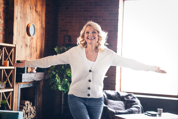 Poster - Photo of aged cheerful lady opened arms welcome you wear white cardigan loft interior house indoors