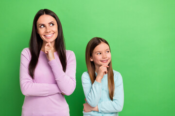 Poster - Photo of two people mother daughter hand touch chin look empty space isolated on bright green color background