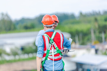 Wall Mural - Two professional engineers or technician inspector working and checking to control and maintenance at solar panels farm system, Renewable energy and alternative sustainable innovation, sunlight power.