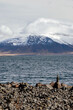landscape of stacking stone at coast with snow mountain in Iceland 