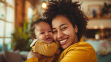 Young Mother With Her Little Daughter In Her Arms Smiling Very Happy, Mother's Day Concept.