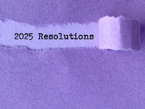 New Year Concept - 2025 resolutions behind torn paper background. Stock photo.