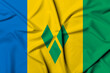 Beautifully waving and striped Saint Vincent and the Grenadines flag, flag background texture with vibrant colors and fabric background