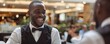 Man in waiter attire serving at upscale restaurant with joyful expression. Professional service and hospitality concept.