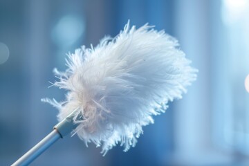 Aufkleber - Macro shot of an ethereal white feather duster held against a soft blue background, highlighting its delicate and clean state
