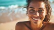 Close-up of a smiling woman on a beach, her face exuding happiness and relaxation