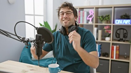 Canvas Print - Confident young hispanic man's earnest look, perfect blend of a carefree yet serious expression while donning headphones in radio studio