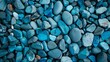 A detailed texture of blue pebbles, creating a soothing and abstract natural background