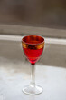 red Liqueur glass on grey surface
