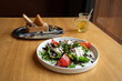 Salad with arugula, tomato, balsamic vinegar and mozzarella cheese