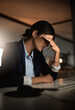 © peopleimages.com - Night, headache and tired businesswoman with stress for migraine pain, burnout risk or depression. Debt, overtime and consultant frustrated by career crisis with mistake, anxiety or fatigue in office