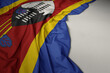 waving national flag of swaziland on a gray background.