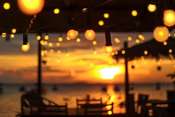 Wall Mural - blurred bokeh light on sunset with yellow string lights decor in beach restaurant.
