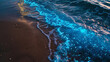 luminous blue waves washing up on sandy beach in twilight bioluminescence