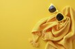 Sunglasses and Towel on Yellow Background