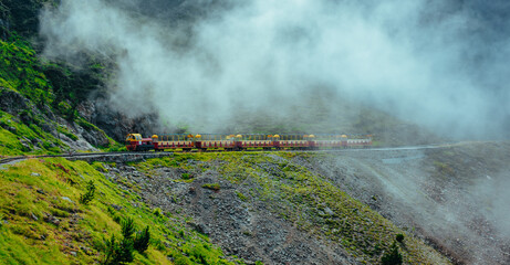 Sticker - Mountains train in Alps in a foggy weather