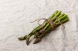 Green asparagus on a linen tablecloth with copy space