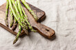 Green asparagus on a wooden cutting board