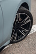 Front wheel of modern car with a rims and tyre