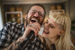 © Miljan Živković - Adult couple caucasian sign karaoke on microphone at home