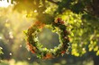 Spring floral wreath on the tree in the garden. Sunny green natural background. Summer solstice concept. Symbol of Beltane.