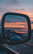 beautiful sunset on the seashore, reflection in the rearview mirror, on the car