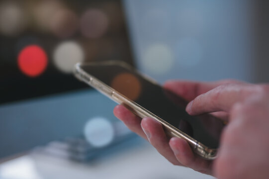 Person using a social media marketing on mobile smartphone, hand using smartphone typing, chatting conversation in chat box icons pop up