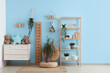 © Pixel-Shot - Interior of stylish children's room with wooden stadiometer, chest of drawers and toys