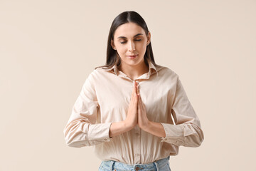 Sticker - Beautiful woman praying on light background