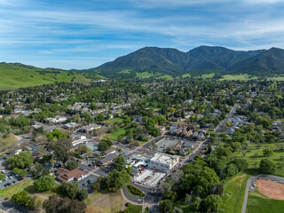 Wall Mural - Drone photos over downtown Clayton, California with businesses, green hills and a blue sky