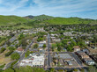 Drone photos over downtown Clayton, California with businesses, blue skies, green hills and room for text