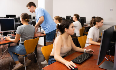 Canvas Print - Portrait of young female student studying in university computer class