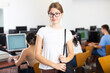 © JackF - Portrait of smart female teenager in glasses standing in the middle of computer class, holding the handle of the bag and looking at camera