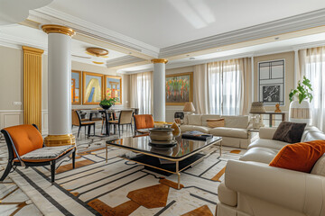 A large living room with a white couch and two orange chairs