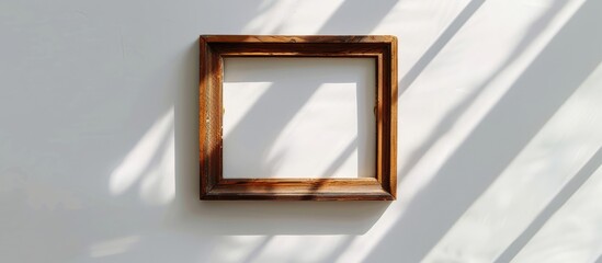 Poster - Wooden picture frame placed against a white backdrop, accentuated by gentle shadows.