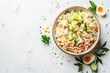 Russian style imitation crab salad with crab sticks corn eggs cucumber and rice on white background with text space Top view