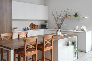 Wall Mural - Interior of light kitchen with counters, table and willow branches in vase